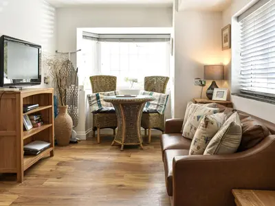 a living room with a couch and a table at Trenpeskador - Uk39442 in Saint Columb Minor