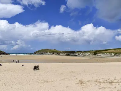 a group of people sitting on a sandy beach at Trenpeskador - Uk39442 in Saint Columb Minor