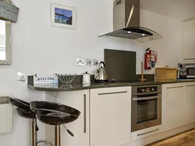 a kitchen with a stove and a counter top at Trenpeskador - Uk39442 in Saint Columb Minor