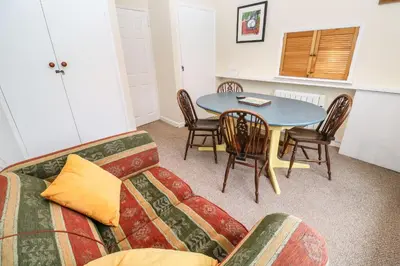 a living room with a couch and a table at Flat 6 in Falmouth