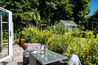 a table in the middle of a garden at Chi Lowarth in Helston