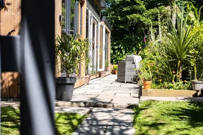 a sidewalk next to a house with plants at Chi Lowarth in Helston