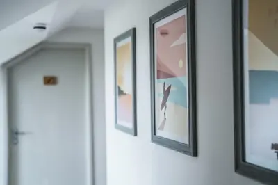 a row of framed pictures hanging on a wall at Macdonald's Farm in Saint Ervan