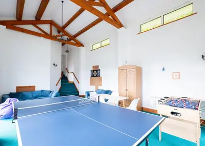a blue ping pong table in a living room at Beach Haven in Wadebridge