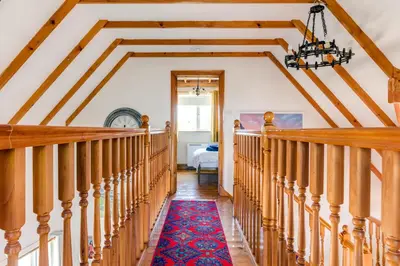 a staircase in a house with wooden ceilings at Baywatch Sands in Wadebridge