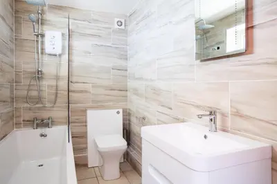 a bathroom with a toilet and a sink and a shower at Baywatch Sands in Wadebridge