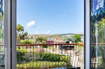 a view of a balcony with a view of a yard at Baywatch Sands in Wadebridge
