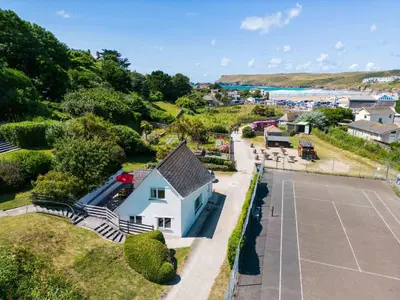 an aerial view of a house with a tennis court at Baywatch Sands in Wadebridge