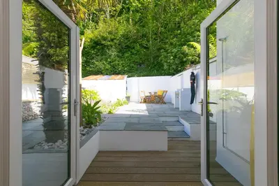 a glass door opens to a patio with a view at Hillywych Studio in Redruth