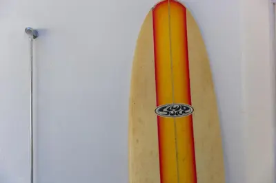 a surfboard leaned up against a wall at Hillywych Studio in Redruth