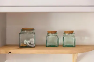 three glass jars sitting on a wooden shelf at Hillywych Studio in Redruth