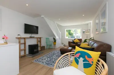 a living room with a couch and a television at Hillywych Studio in Redruth