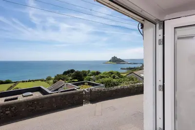 a view of the ocean from the balcony of a house at Stunning Sea Views, Wi-Fi, Pet Friendly in Marazion