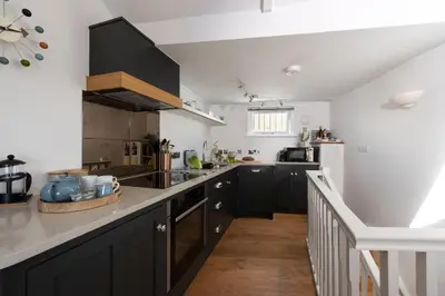 a kitchen with black cabinets and a counter top at Stunning Sea Views, Wi-Fi, Pet Friendly in Marazion