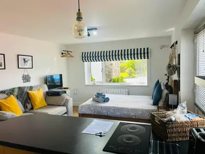a living room with a bed and a table at West Moor View Apartment in Launceston