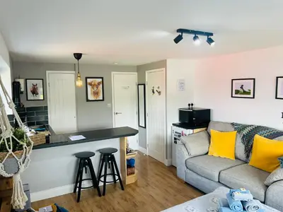 a living room with a couch and a table at West Moor View Apartment in Launceston