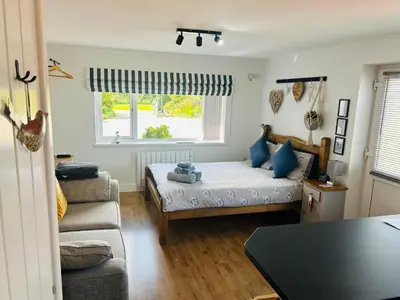 a living room with a bed and a couch at West Moor View Apartment in Launceston