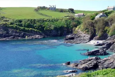 a view of a beach with blue water at Lovely Cornish cottage in small village setting in Saint Hilary