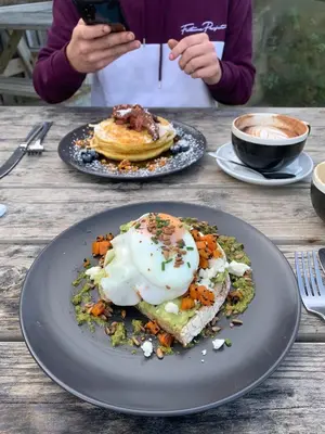 a person taking a picture of a plate of breakfast food at Cornish coastal retreats- 74 newquay view in Porth