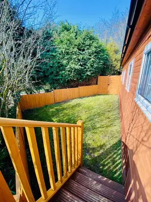 a wooden deck with a fence and a yard at The Beehive -Stunning Views - Hot Tub - Romantic in Launceston