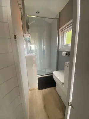 a small bathroom with a shower and a toilet at The Beehive -Stunning Views - Hot Tub - Romantic in Launceston