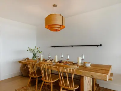 a dining room with a wooden table and chairs at Chi An Mor in Charlestown