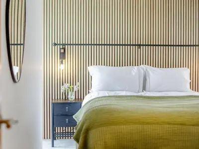 a bedroom with a bed and a wooden wall at Chi An Mor in Charlestown