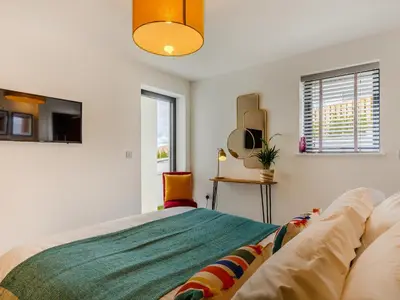 a bedroom with a bed and a couch at Chi An Mor in Charlestown