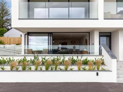 a white house with plants in front of it at Chi An Mor in Charlestown