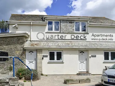 a white building with a sign for a vendor desk at Pennti Treth - Uk39455 in Saint Columb Minor