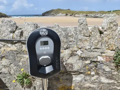 a parking meter next to a stone wall with a beach at Pennti Treth - Uk39455 in Saint Columb Minor