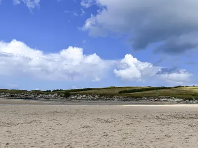 a sandy beach with a blue sky and clouds at Pennti Treth - Uk39455 in Saint Columb Minor