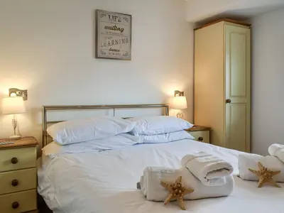 a bedroom with a bed with towels on it at Pennti Treth - Uk39455 in Saint Columb Minor