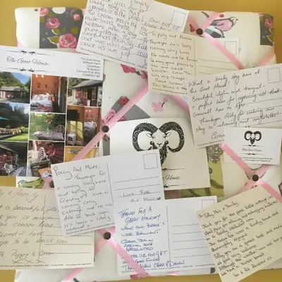 a collage of notes and signatures on a wall at Romantic, secluded cottage in Cardinham Woods, Cornwall in Cardinham