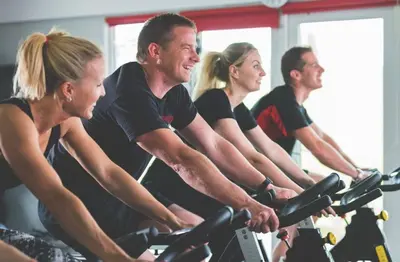 a group of people riding on bikes in a gym at Trevone House with Hot Tub on Retallack Resort in Padstow