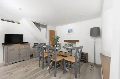 a dining room with a table and chairs at 2 Bedroom Home in Marazion, views of St Michael's Mount in Marazion