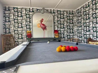 a billiard table with balls on it in a room at Baywatch Mawgan Porth Spacious Home sleeps 9, Games room, Parking & Garden in Mawgan Porth