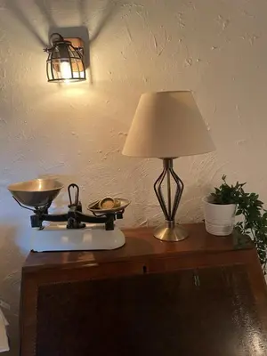 a lamp on top of a table with a scale at Buttercup Cottage, located in the gateway to Eden! in Saint Blazey