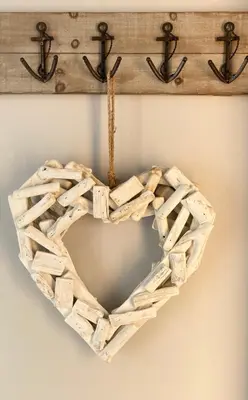 a wooden heart shaped wreath hanging on a wall at Looe with a View - Entire apartment with FREE allocated parking in Looe