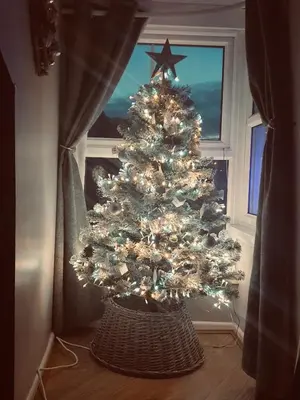 a christmas tree in a room with a window at Looe with a View - Entire apartment with FREE allocated parking in Looe