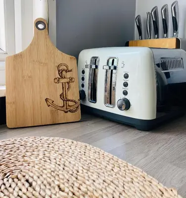 a toaster next to a cutting board and a toaster at Looe with a View - Entire apartment with FREE allocated parking in Looe