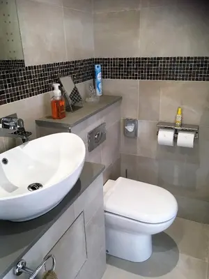 a bathroom with a white sink and a toilet at Loggans Lodge in Hayle
