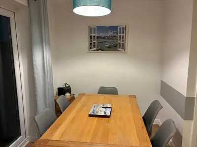 a conference room with a wooden table and chairs at Stylish 3 bed home with allocated parking for 2 in Liskeard