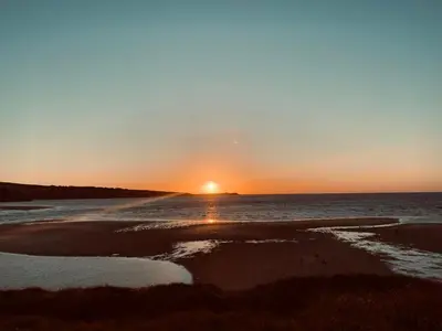 a sunset on the beach with the sun setting at Gold 10 - Cornish Coastal Retreats in Saint Hilary