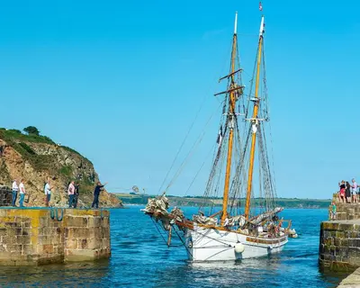 a sail boat is docked at a pier at Charlestown cottage, Woodburner, Gardens & Parking in Charlestown