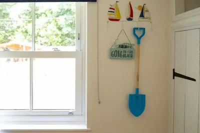 a room with a window and a sign on the wall at Charlestown cottage, Woodburner, Gardens & Parking in Charlestown