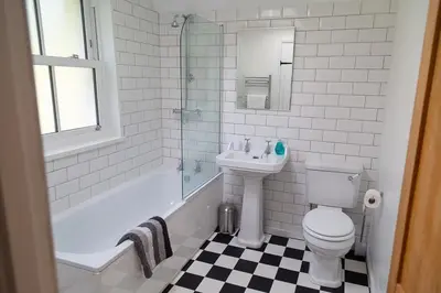 a bathroom with a sink and a toilet and a bath tub at Charlestown cottage, Woodburner, Gardens & Parking in Charlestown