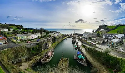 an aerial view of a town with boats in a river at Charlestown cottage, Woodburner, Gardens & Parking in Charlestown