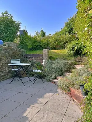 a picnic table and a bench in a garden at Finest Retreats - Primrose Cottage in Tywardreath