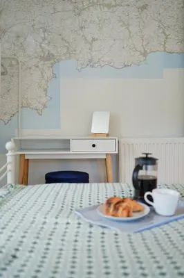 a plate of croissants and a cup of coffee on a bed at Finest Retreats - Primrose Cottage in Tywardreath